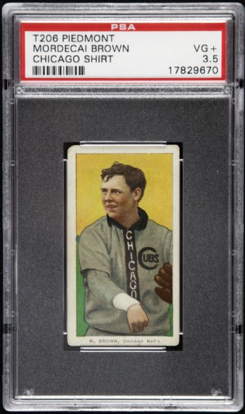 1909 - 11 T206 Mordecai Three Finger Brown Chicago Cubs Shirt Piedmont Back Card - PSA VG+ 3.5