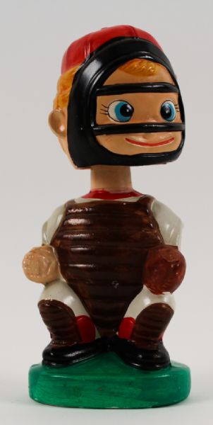 1960s Catcher Green Oval Base Bobbing Head Doll Bank